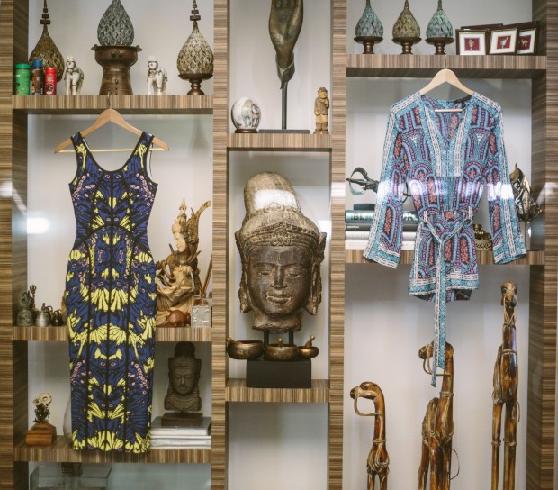 A few of Maggie’s printed pieces: a dress by local designer Patty Ang (left) and a top from BCBG Max Azria (right). Behind (what?) is their home’s “wall of knickknacks,” as she describes it. “I like to take a piece of memory and history from all the places that I visit,” she says as she runs me through the elaborate candleholders from Chiang Mai, ivory horses passed on to her from her grandmother, and her collection of small rain drums.