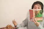 girl reading a book and eating tikoy